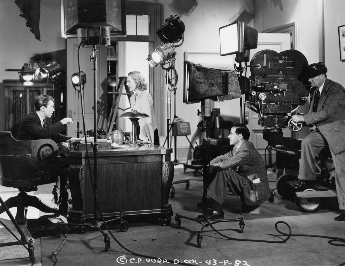 Frank Capra beside the camera on the set of Mr. Smith Goes to Washington with James Stewart and Jean Arthur, 1939.