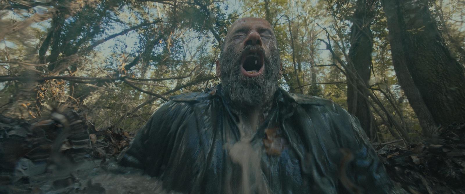 A man screams in a flooded forest. Still from OBITUS.
